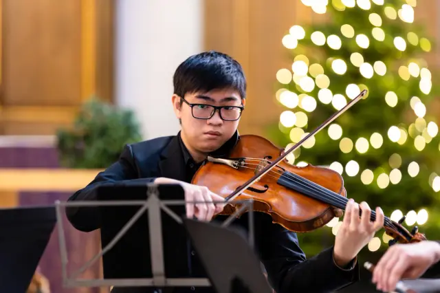 Sean Lee playing the viola during a performance